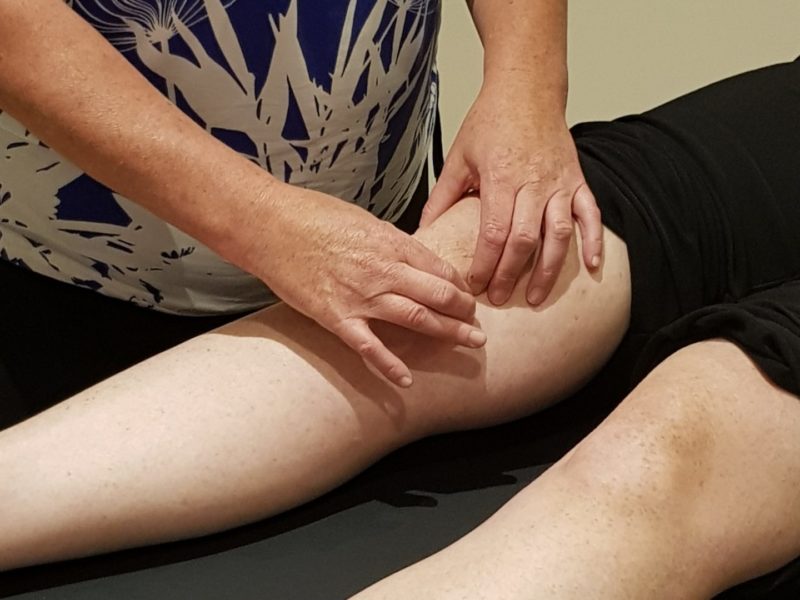 Therapist treating persons knee