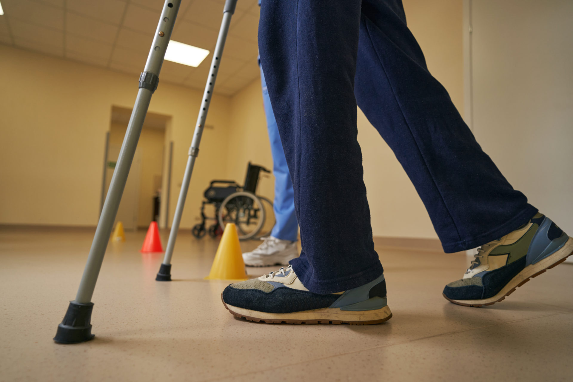 Client with physical disability using crutches during rehabilitation